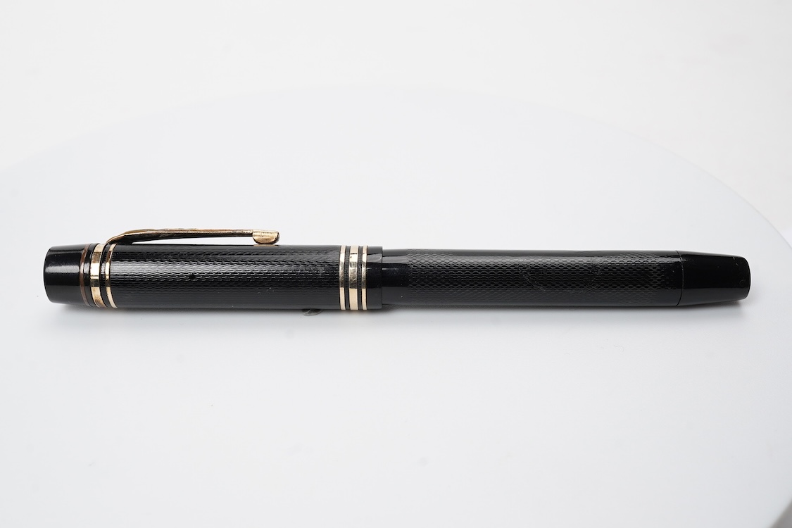 A De la Rue Onoto piston fill fountain pen in large size with ornate cap banding and fitted with DLR Onoto No.5 14ct. nib